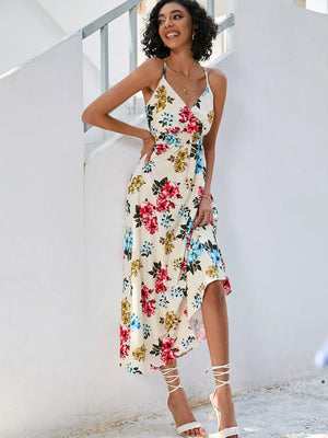 Chic floral midi dress with spaghetti straps, V-neck, and a wrap-style skirt in cream with red, blue, and yellow flowers.