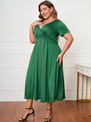 Emerald twist-front midi dress in dark green with short sleeves and a V-neck.