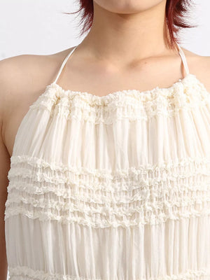 Cream halter dress with tiered ruffles and gathered bodice