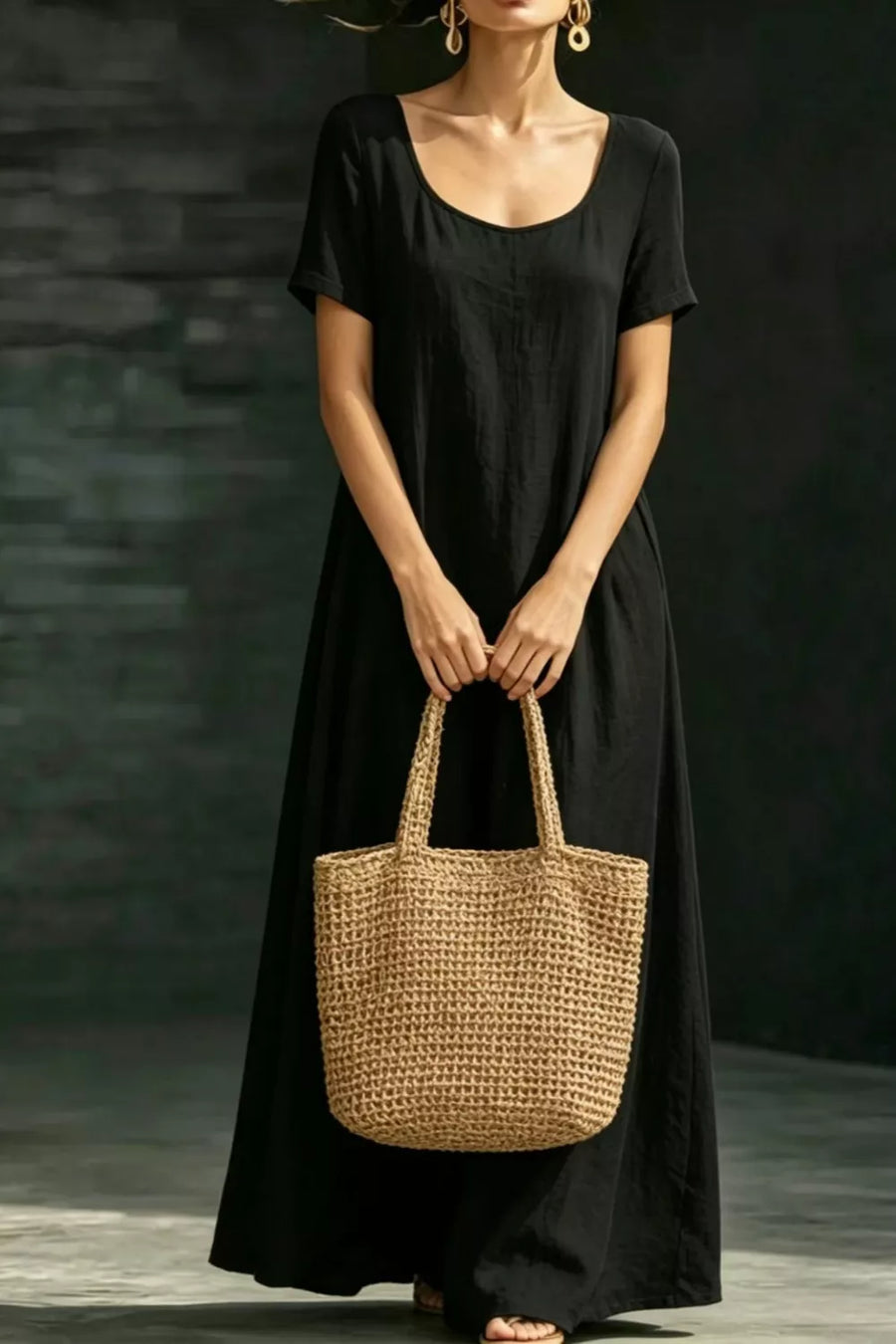 Black A-line maxi dress with short sleeves and pockets, made of 100% polyester.