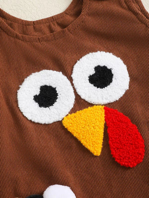 Brown corduroy baby dress with turkey face applique.