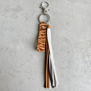 Textured leather tassel keyring with mixed color tassels and silver hardware.