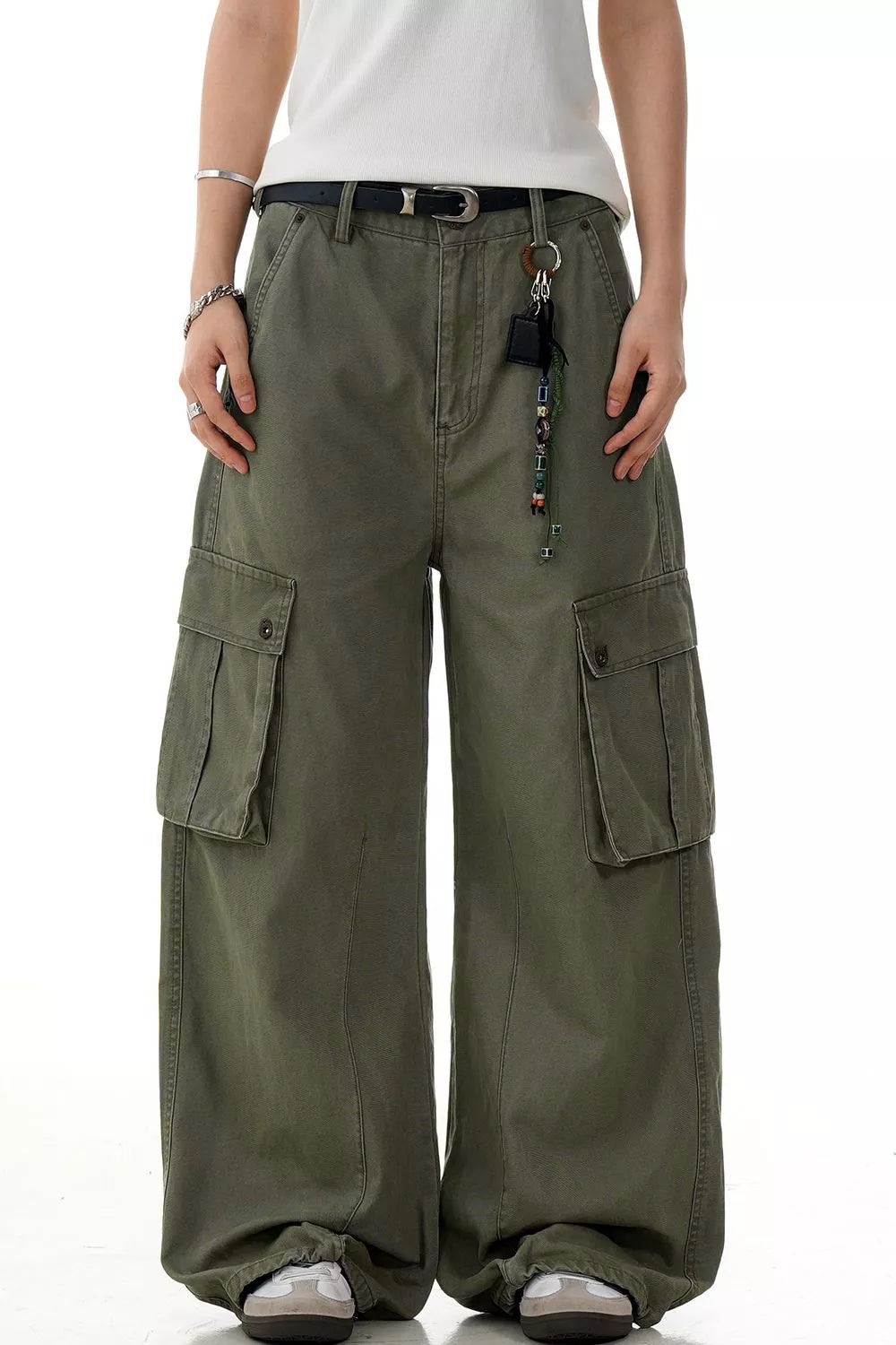 Olive green wide-leg cargo pants with large side pockets and a relaxed fit.