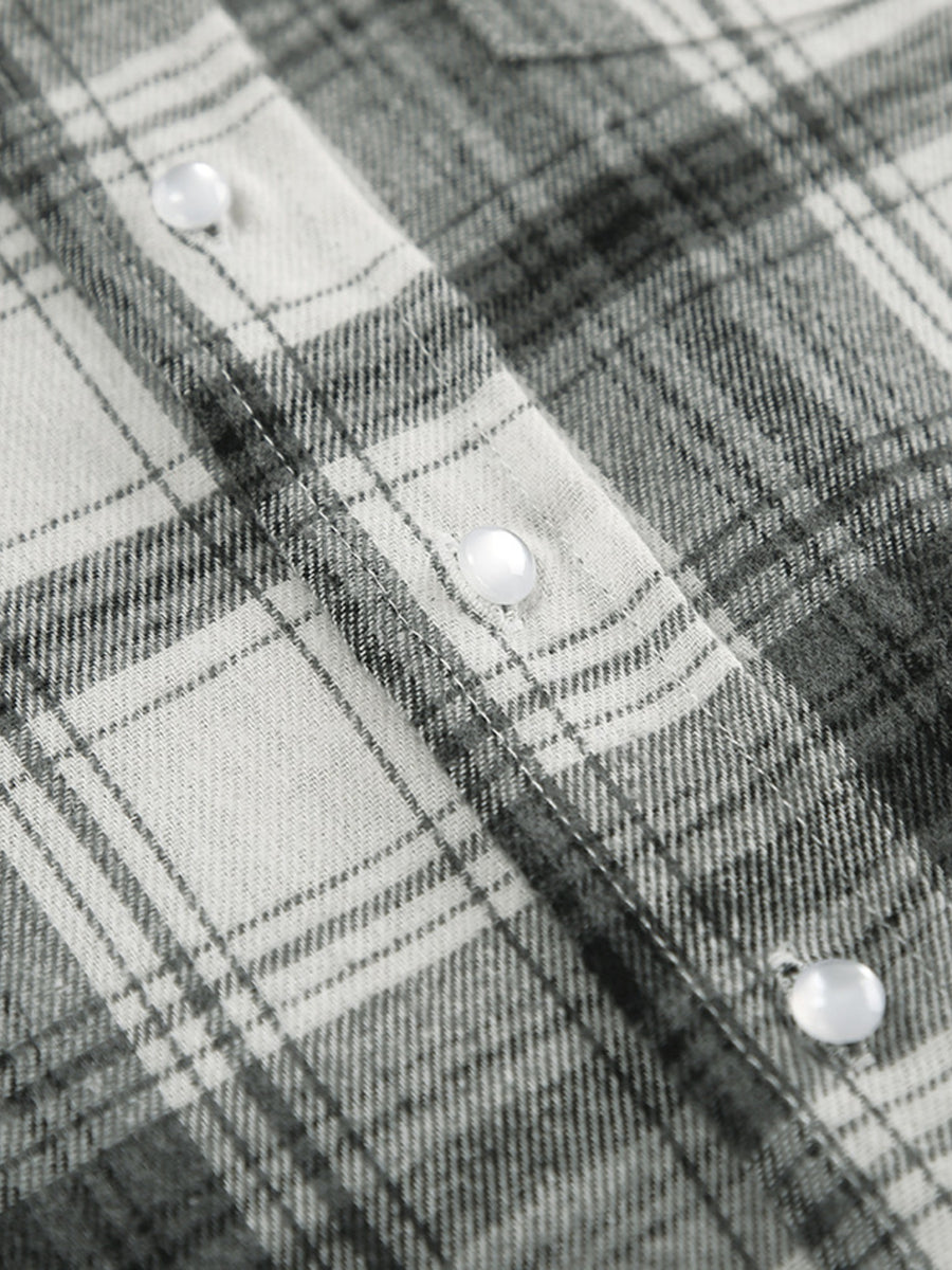 Button-up long sleeve shirt in black and white plaid cotton with pearl buttons.