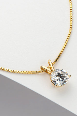 Gold box chain necklace with a classic solitaire moissanite pendant.