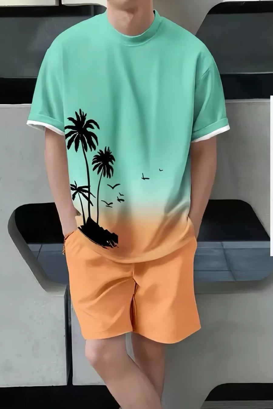 Men's casual set with palm tree graphic tee and orange shorts.