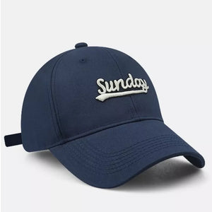 Navy baseball cap with white embroidered Sunday text and adjustable strap
