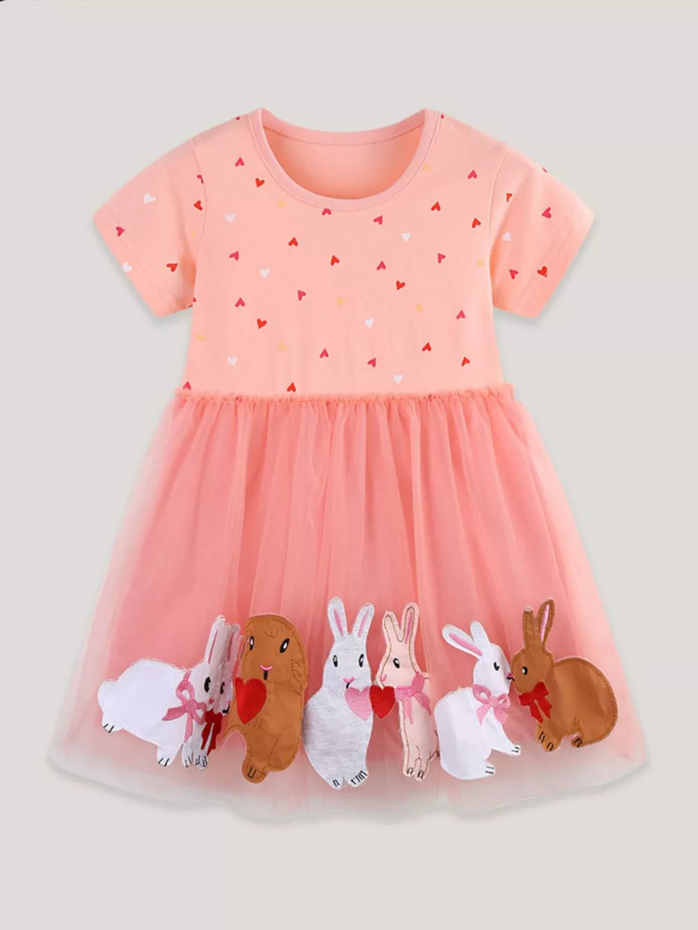Pink cotton baby dress with heart print and tulle skirt featuring bunny appliques.