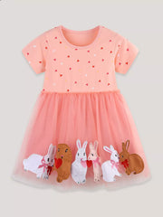 Pink cotton baby dress with heart print and tulle skirt featuring bunny appliques.
