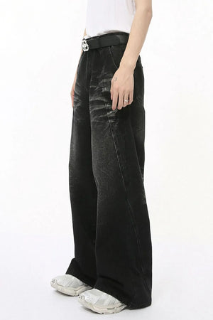 Faded black denim palazzo trousers with a wide leg and distressed details.