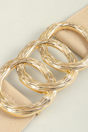 Tan elastic belt with textured gold triple ring buckle detail