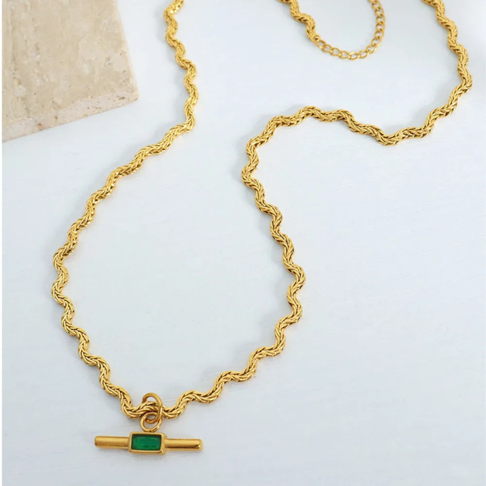 Gold rope chain necklace with emerald bar pendant