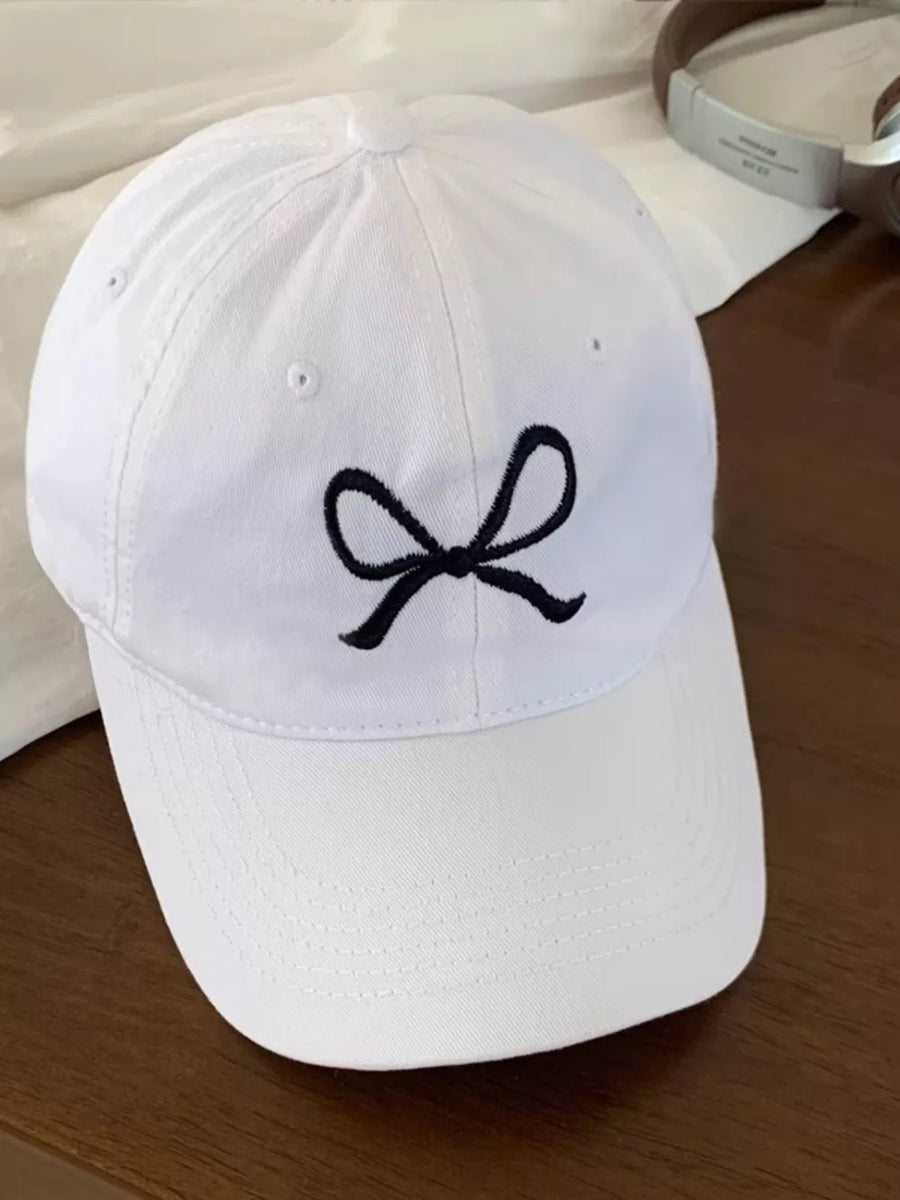 White baseball cap with black embroidered bow detail