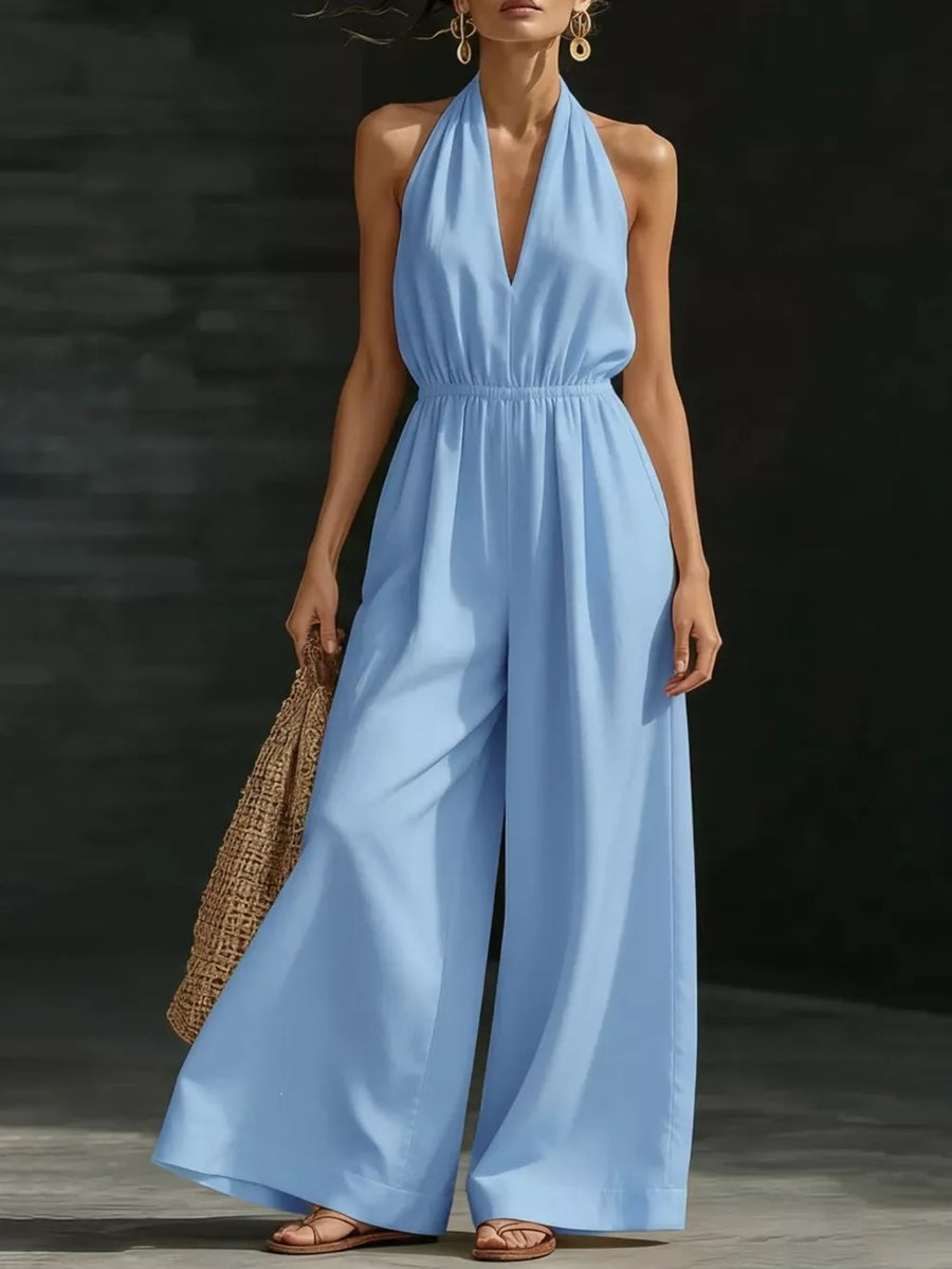 Sky blue halter jumpsuit with wide legs and elastic waist, V-neckline.