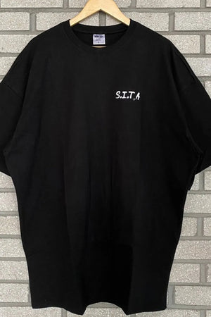 Black oversized t-shirt with white S.I.T.A. text graphic on chest