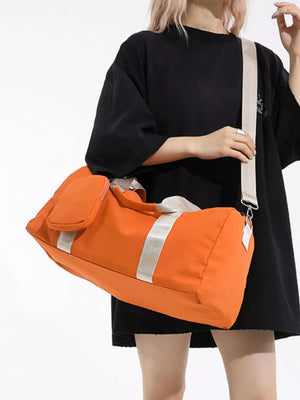 Orange duffle bag with detachable pouch and silver stripe detail.