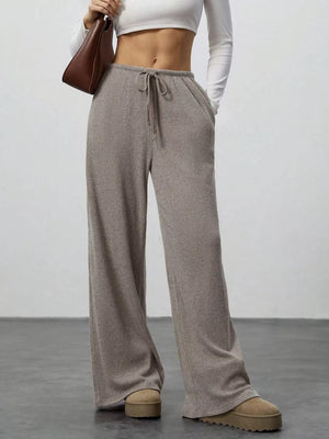 Relaxed wide-leg pants in mocha ribbed knit with drawstring and pockets.