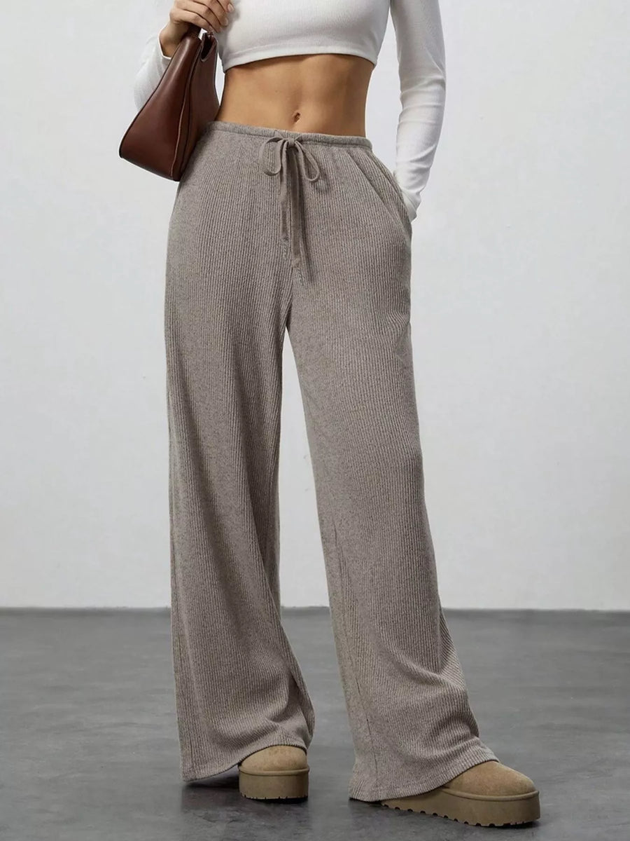 Relaxed wide-leg pants in mocha ribbed knit with drawstring and pockets.