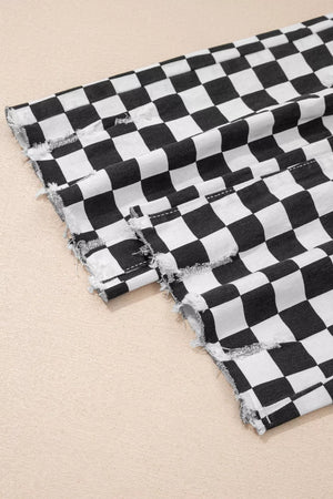 Checkerboard distressed cropped jeans in black and white denim with raw hem detail.