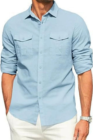 Light blue linen utility shirt with two chest pockets and rolled sleeves.
