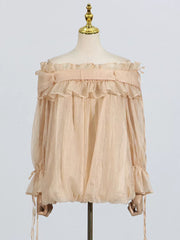 Romantic off-shoulder ruffled blouse in champagne color with billowy sleeves and adjustable ties.
