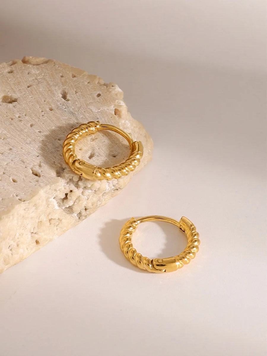 Twisted gold mini hoop earrings with a rope texture detail.