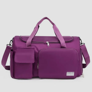 Purple canvas duffel bag with multiple utility pockets and adjustable strap.