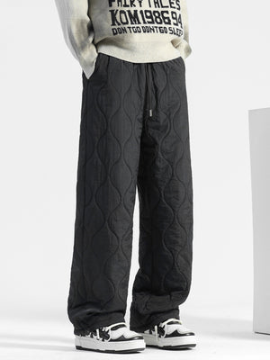 Men's black quilted sweatpants with relaxed fit and drawstring waist.