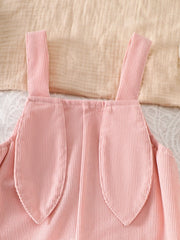 Pink corduroy baby one-piece with bunny ear details on the straps.