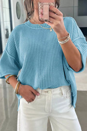 Relaxed blue ribbed knit sweater top with crew neck and short sleeves.