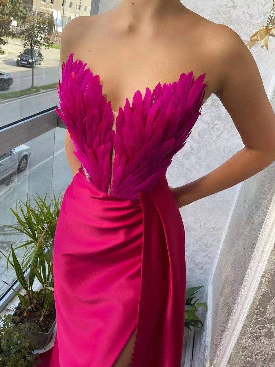 Rose Red feather embellished strapless maxi dress with draped skirt and high slit.