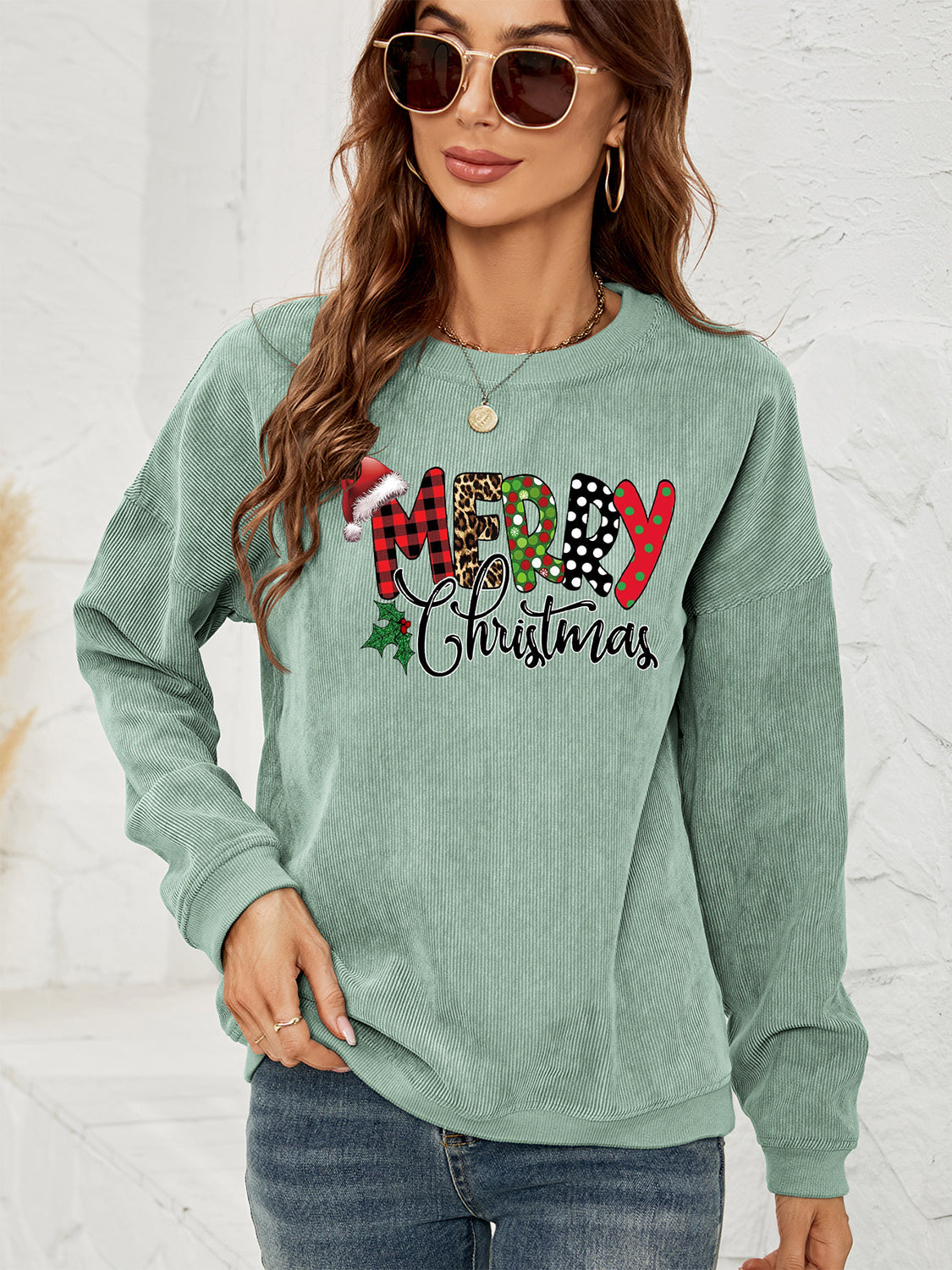 Sage corduroy sweatshirt with Merry Christmas graphic and Santa hat detail.