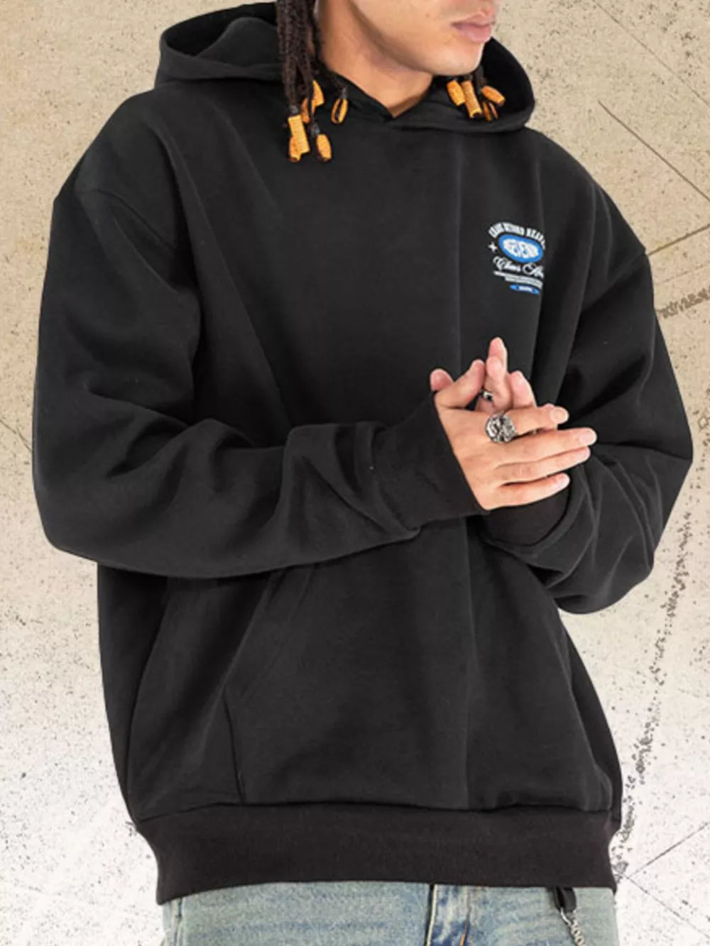 Black graphic hoodie with drawstring hood and front pocket.