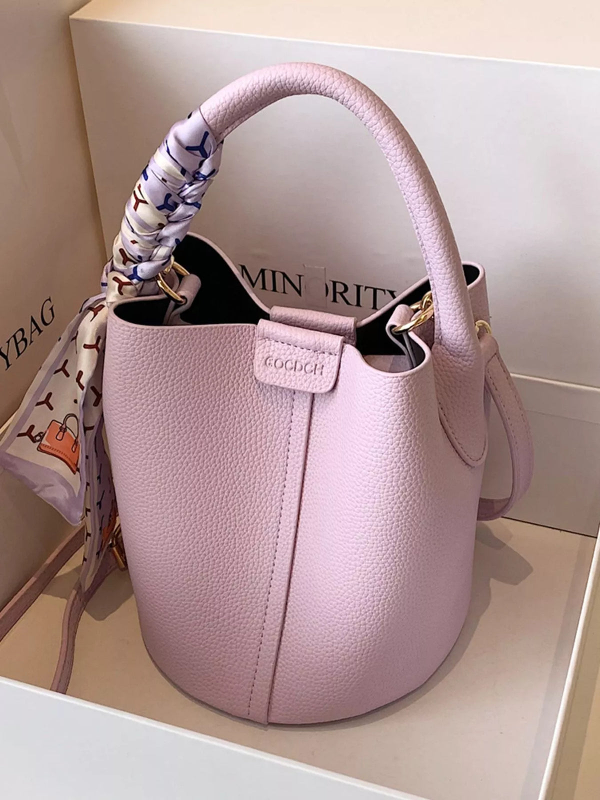 Chic purple bucket crossbody bag with decorative scarf on handle