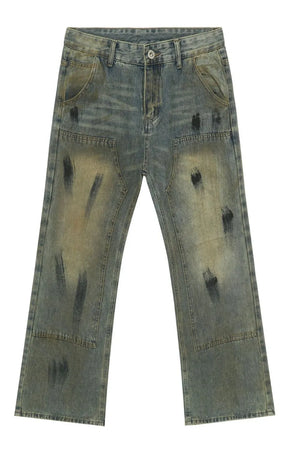 Distressed medium wash denim carpenter jeans with black brushstroke details.
