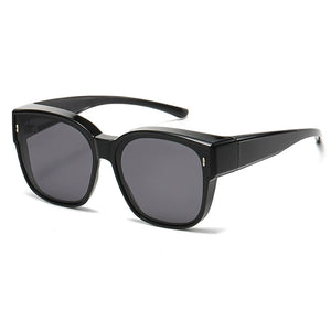 Black oversized sunglasses with dark lenses and a thick frame.