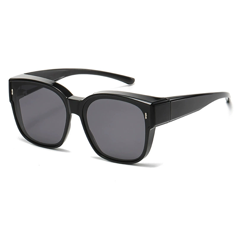 Black oversized sunglasses with dark lenses and a thick frame.
