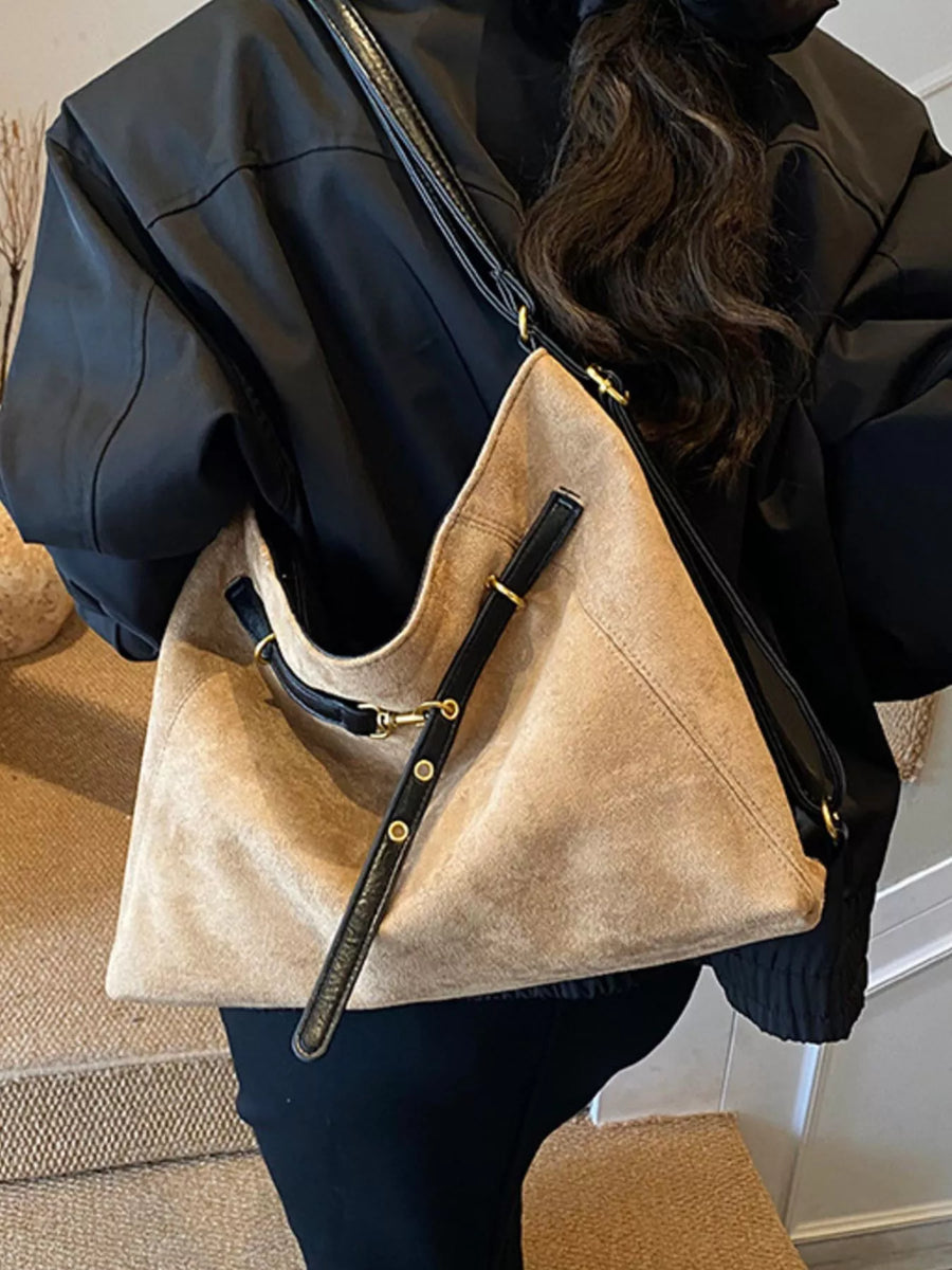Khaki suede large tote bag with black leather trim and gold hardware.