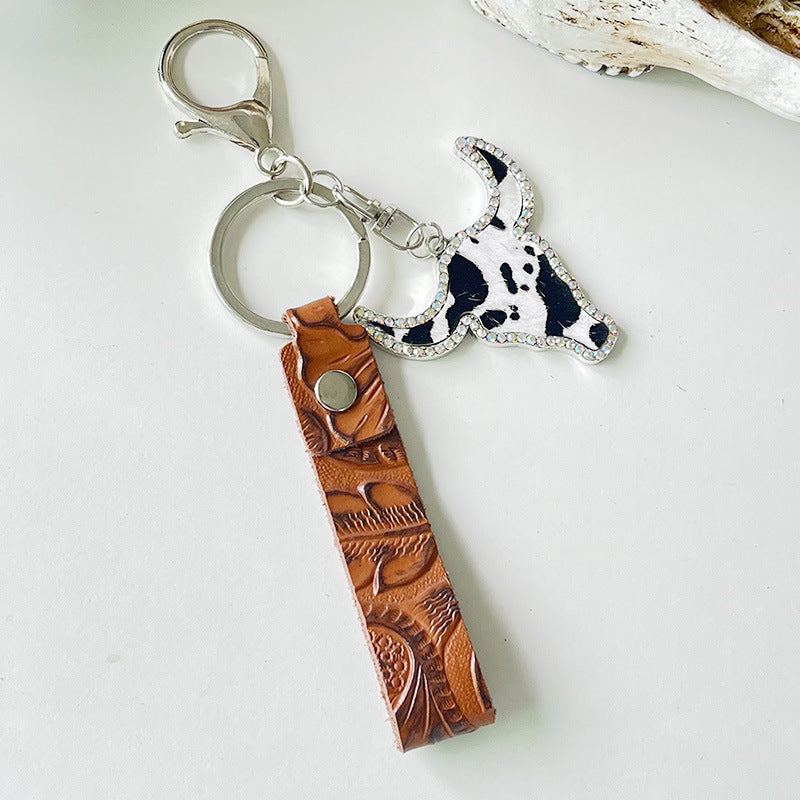 Western keychain with embossed leather strap and crystal bull skull charm