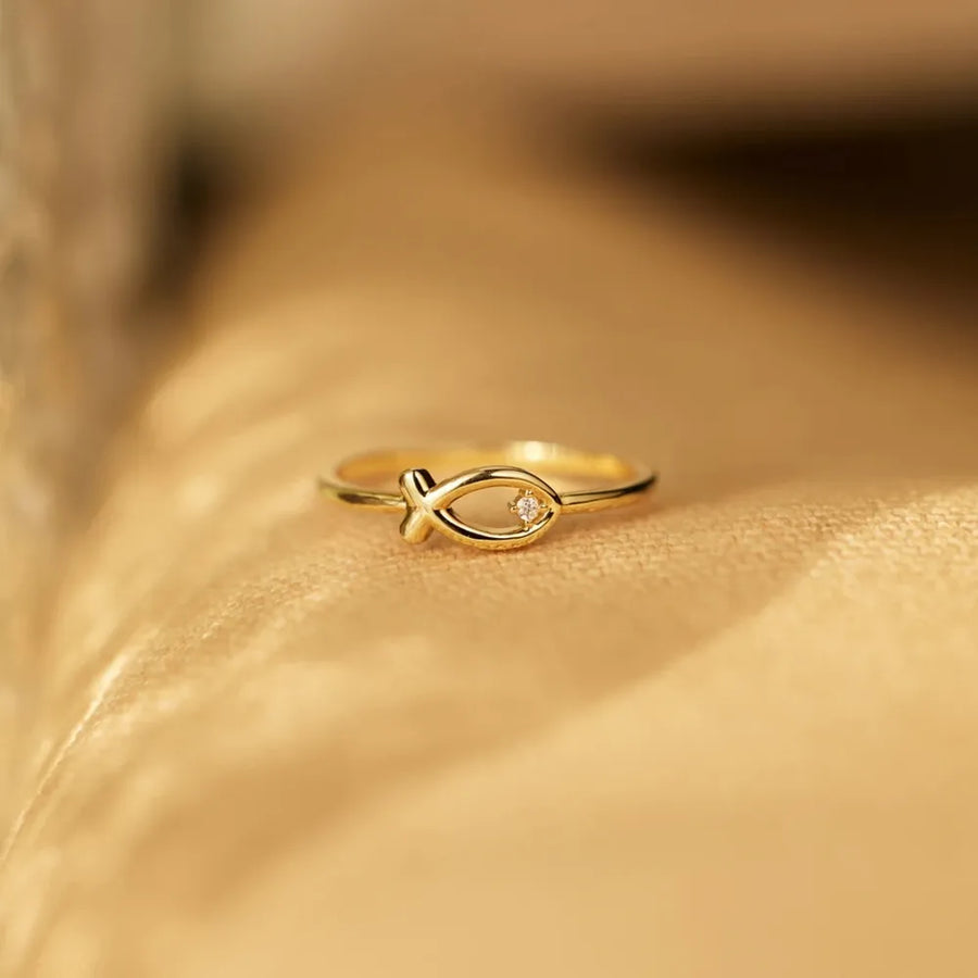 Gold ring with delicate fish motif and small zircon detail