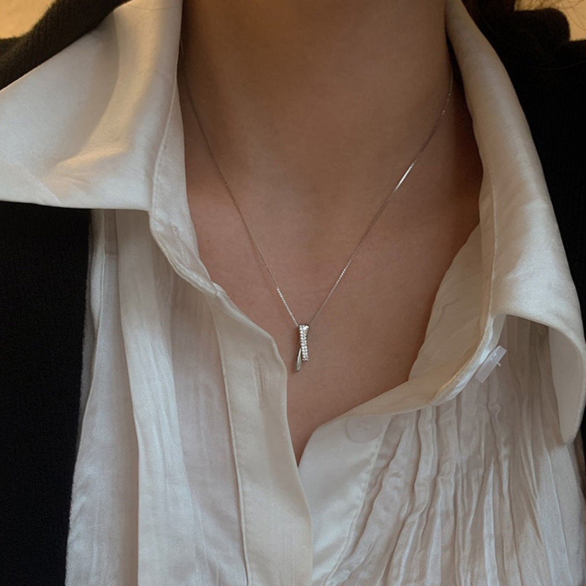 Sterling silver pendant necklace with zircon accents on a box chain