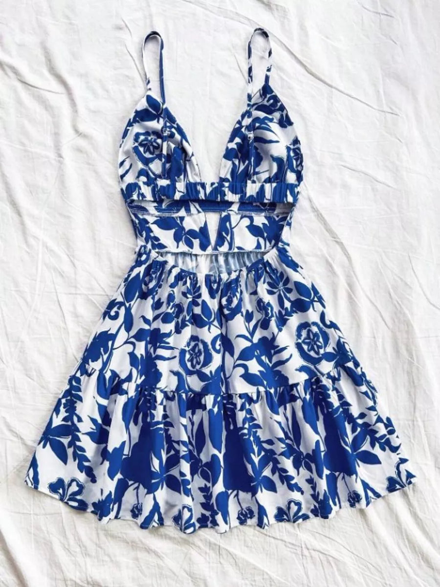 Vibrant floral v-neck mini dress with cutout back and tiered skirt.