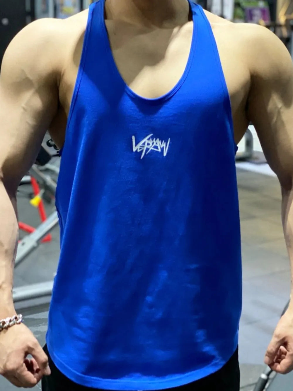 Royal blue performance racerback tank top with white graphic detail and athletic cut.