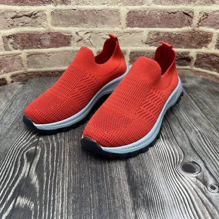 Red sock-fit knit platform slip-on sneakers with a light gray sole.
