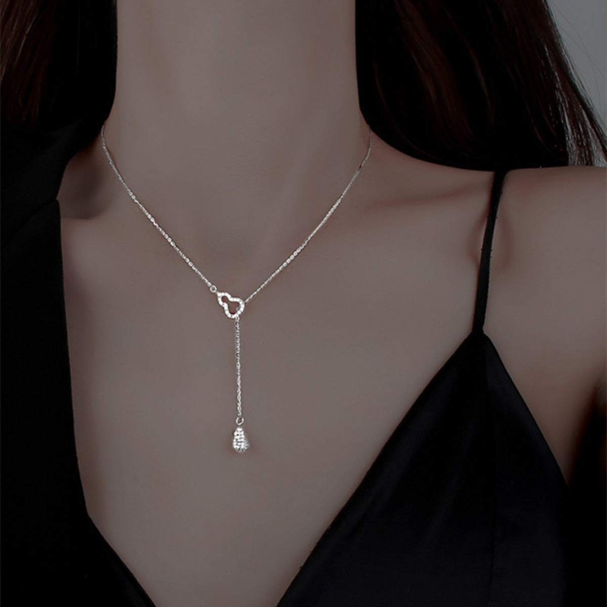 Silver zircon pendant necklace with double gourd charm and delicate chain.