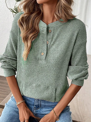 Light green ribbed long-sleeve top with button detail and front pocket.