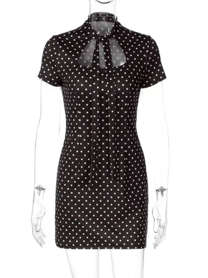 Black polka dot mini dress with short sleeves and a tie-neck cut-out detail.