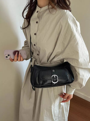 crossbody bag in black featuring buckle detail and straight fit