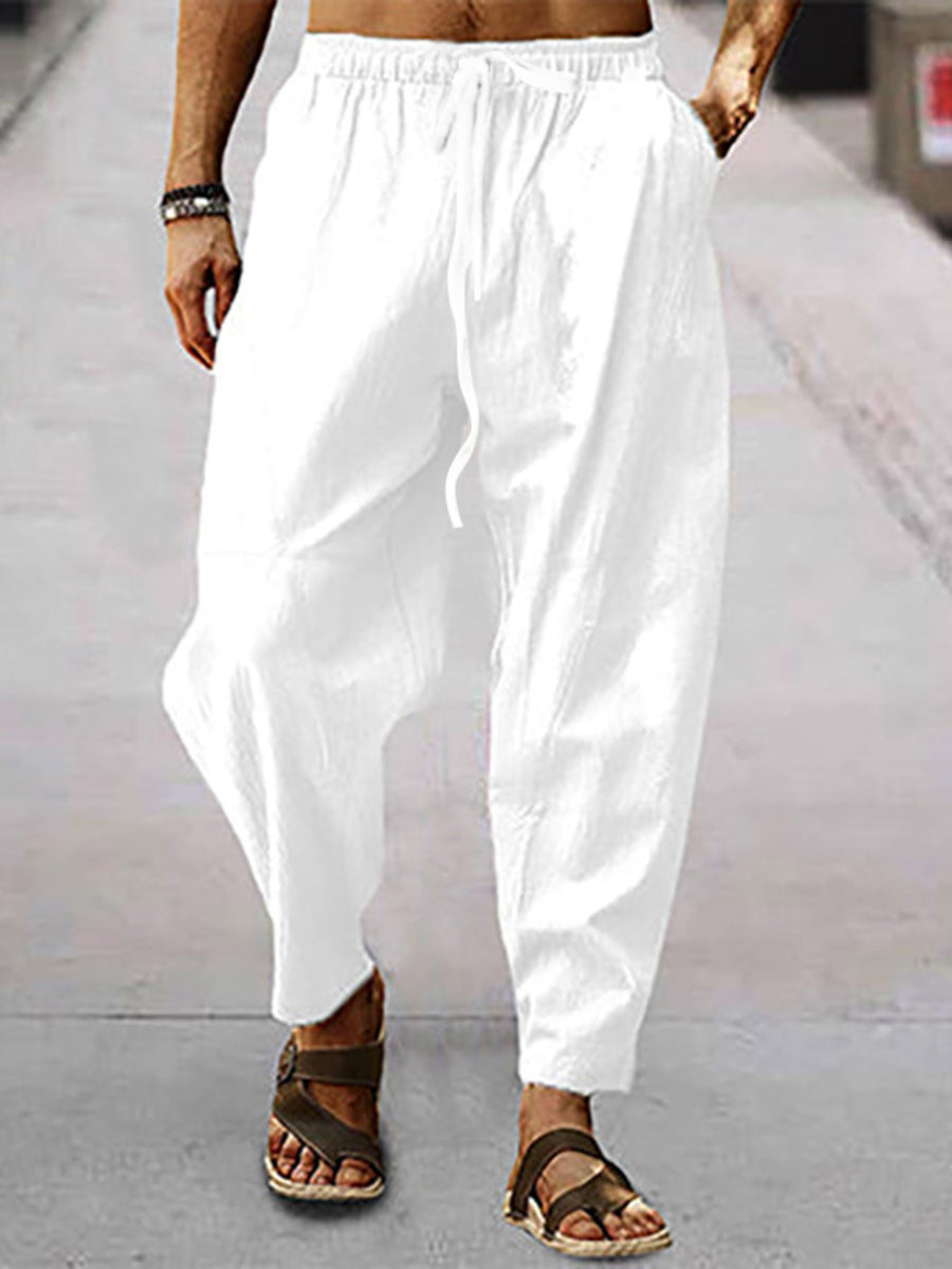 Men's white drawstring wide leg sweatpants with pockets.