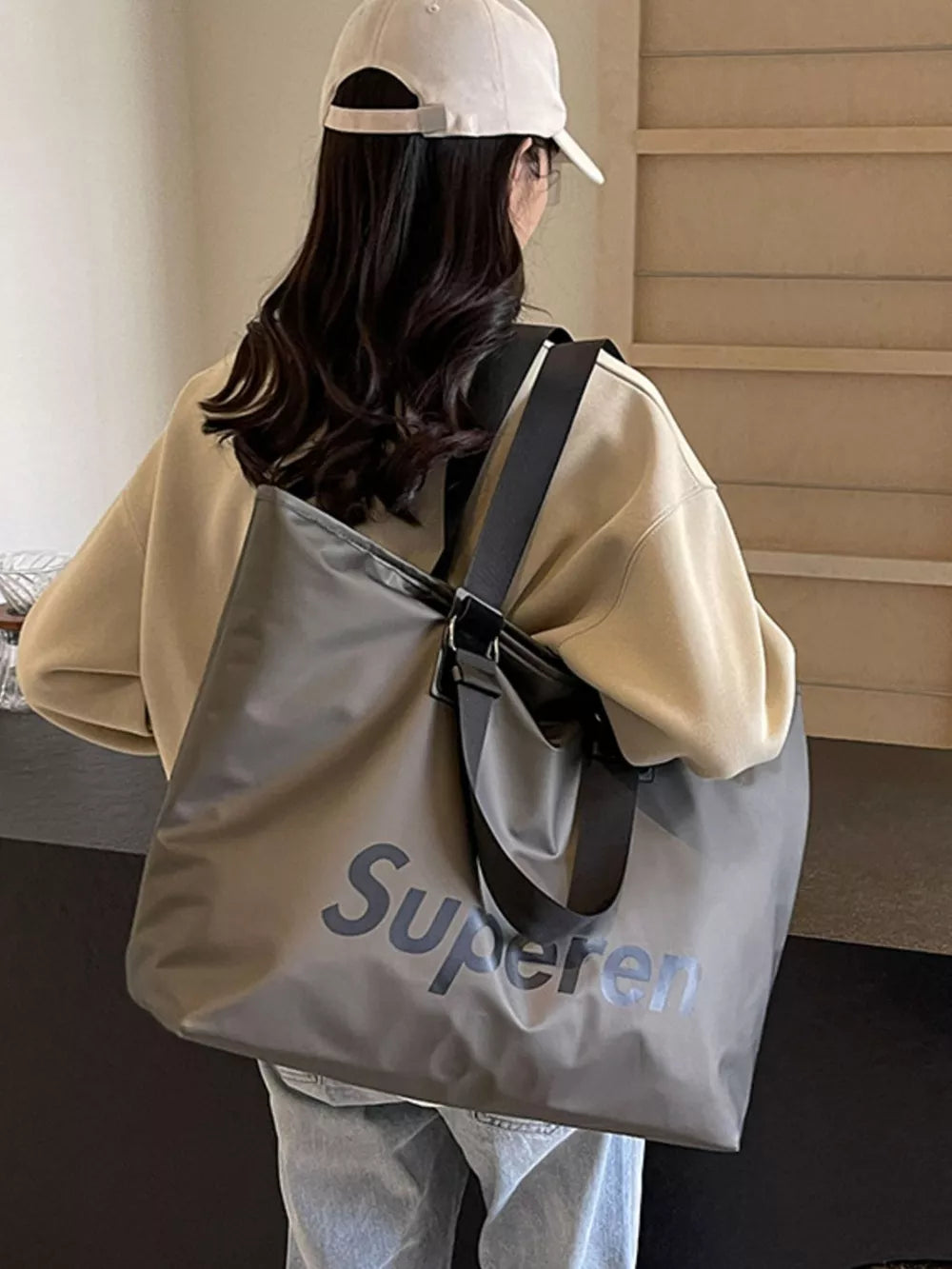 Spacious grey Oxford cloth travel shoulder bag with dark grey "Superen" text graphic.